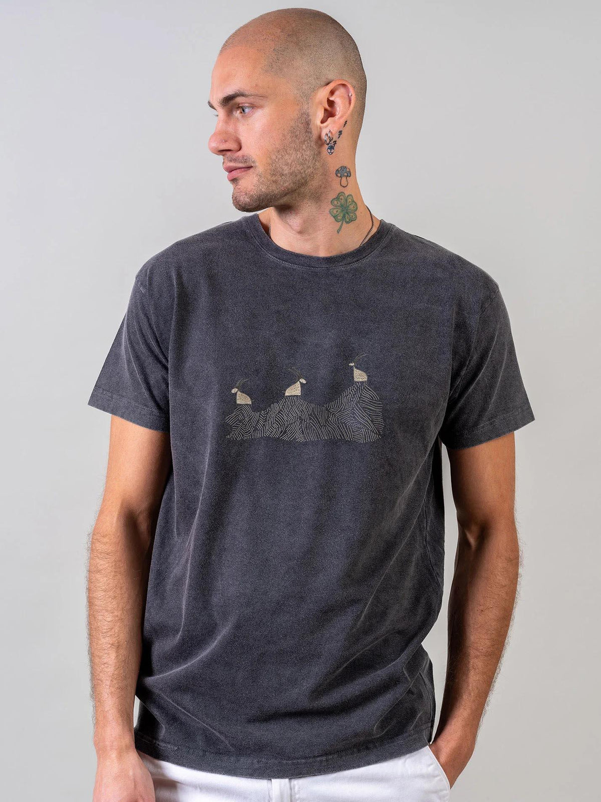 Man in a dark grey ZOE T-shirt with abstract art, modeled for unique Greek cotton apparel.