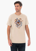 Man wearing a beige ZOE T-shirt with colorful octopus art, Greek cotton, Crete design.